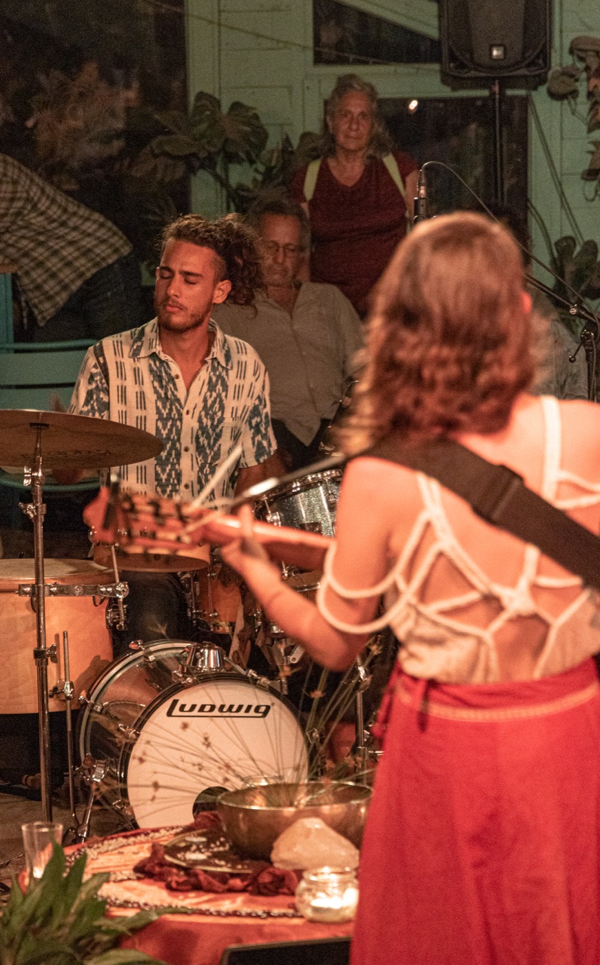 Yuli playing to a small room, with the drummer behind her